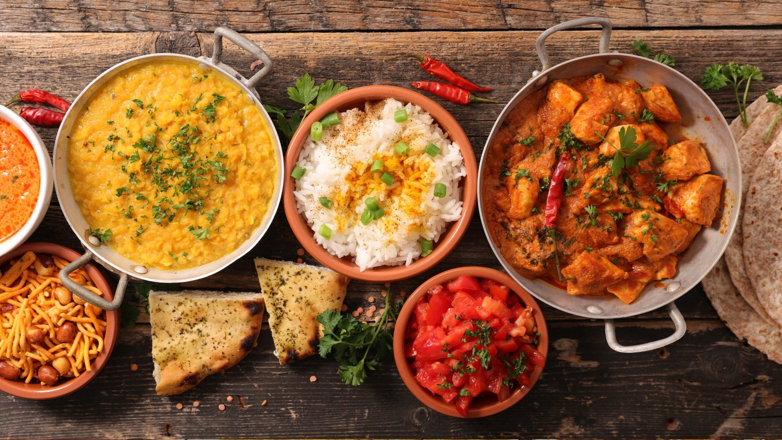 Various Indian dishes on a wooden table